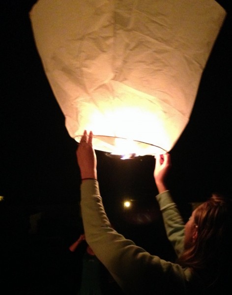 Volunteers in Southwest France light Chinese lanterns at village fete.