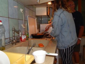 Amanda and Ted, one of our volunteers, cooking dinner